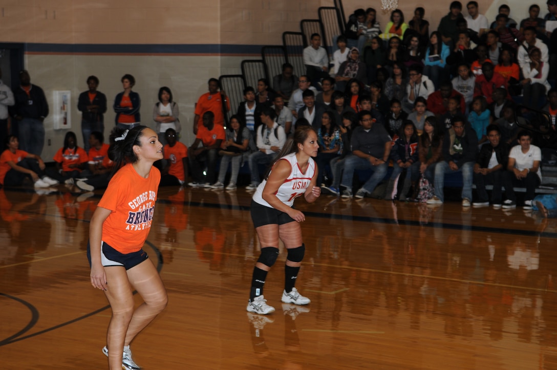 Gunnery Sgt. Vanessa A. Delgado, (right) plays the libero (defensive) position during a volleyball game with high school female athletes at George Bush High School in Houston, Texas.